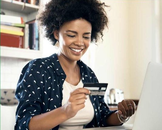 Woman using prepaid card while shopping